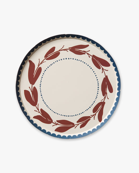 decorative plate with red leaf design on a white background