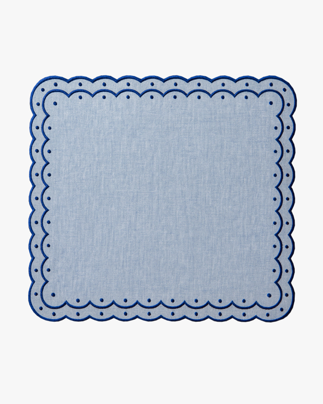 Chambray blue placemat with dark blue scalloped edges