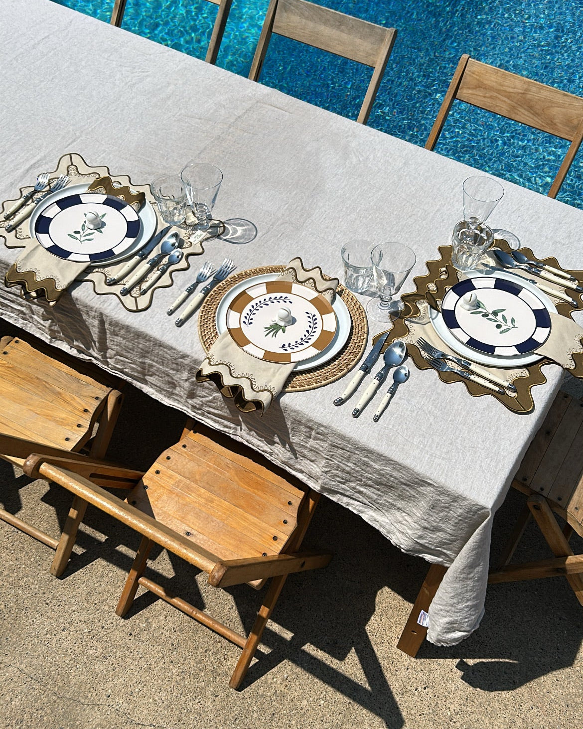 Decorative plates set at a table poolside