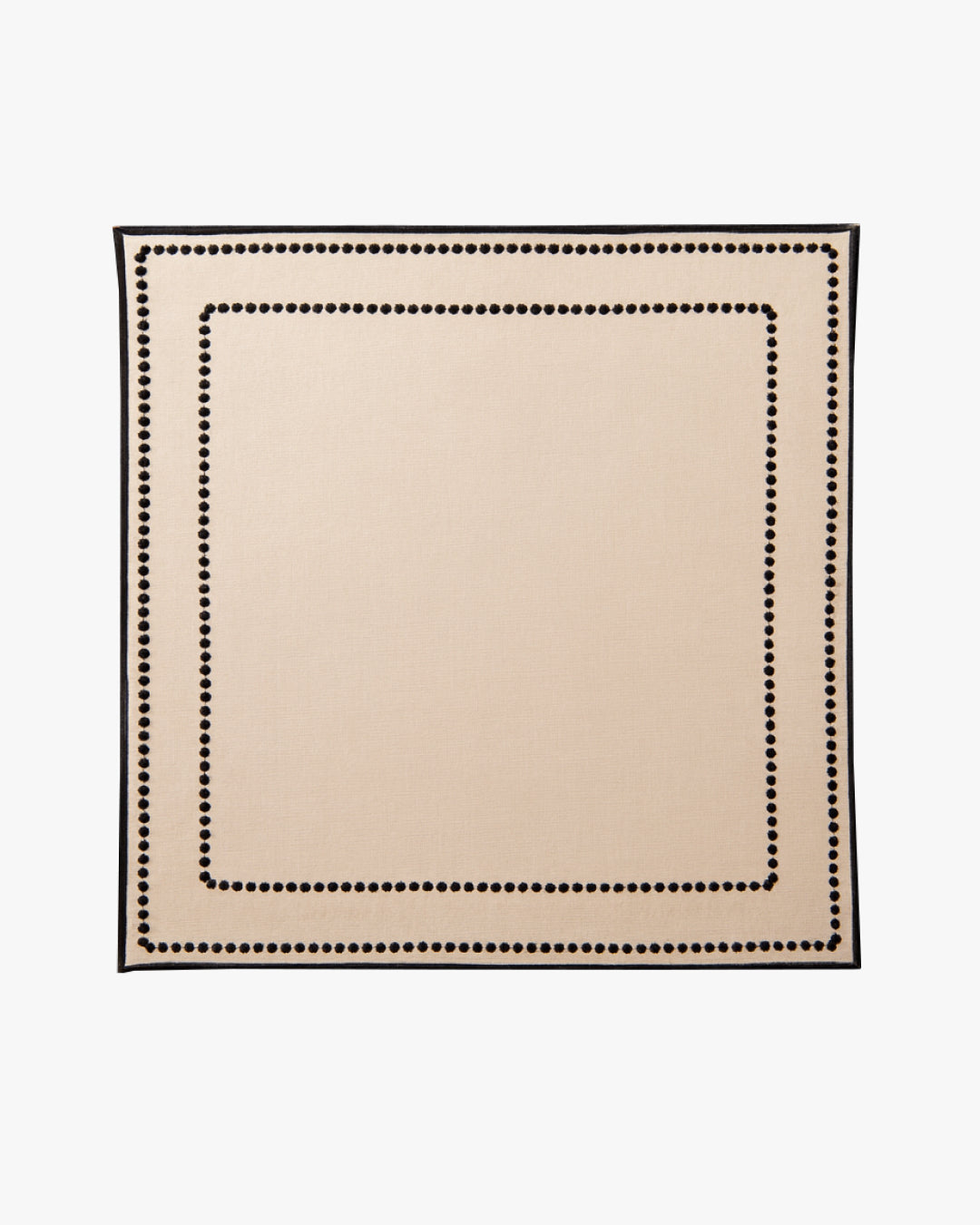 Beige placemat with black border on a white background