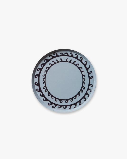 Round blue decorative plate with black intricate design on a light gray background