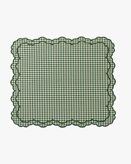 Green checkered placemat with scalloped edge on a white background