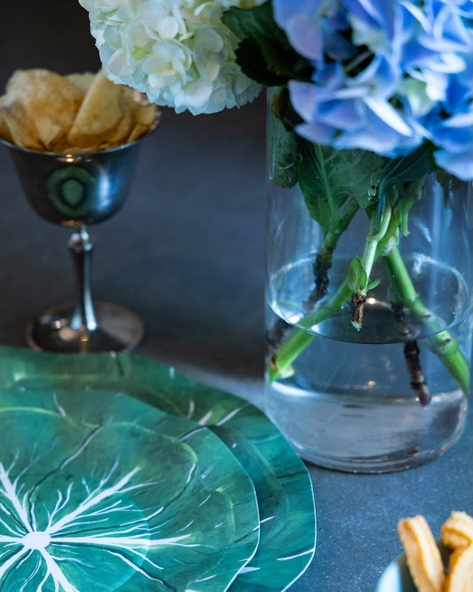 Cabbage style plates with chips and flowers in the background