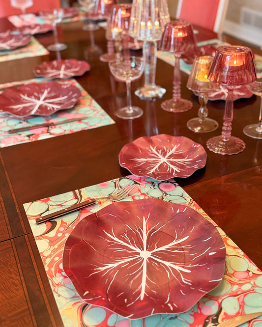 A tablescape featuring burgundy cabage plates