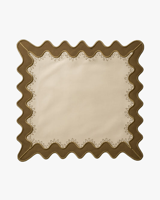 Beige placemat with olive green scalloped edge on a white background