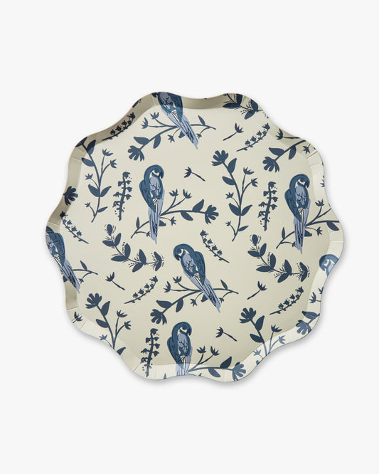 Decorative plate with blue bird and leaf pattern on a beige background