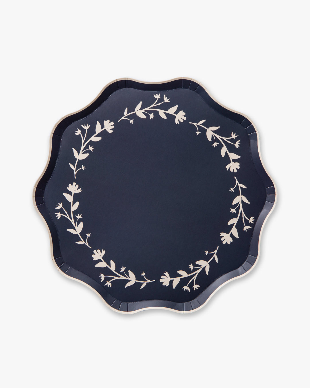 Navy blue plate with white floral patterns on a white background