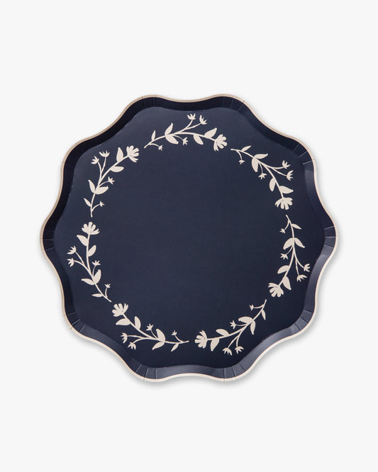 Navy blue plate with white floral patterns on a white background