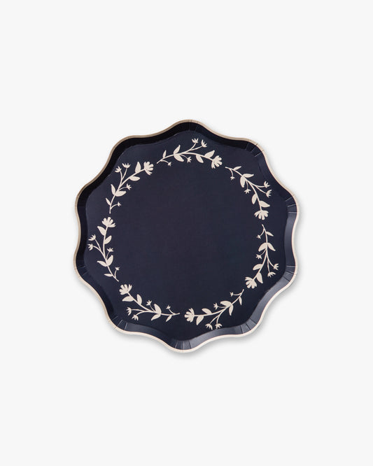 Navy blue plate with white floral patterns on a white background