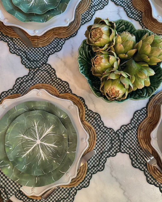 Paper plates with a cabbage design on green checkered placemats