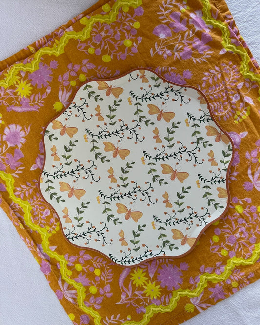 Decorative plate with butterflies on a decorative orange placemat