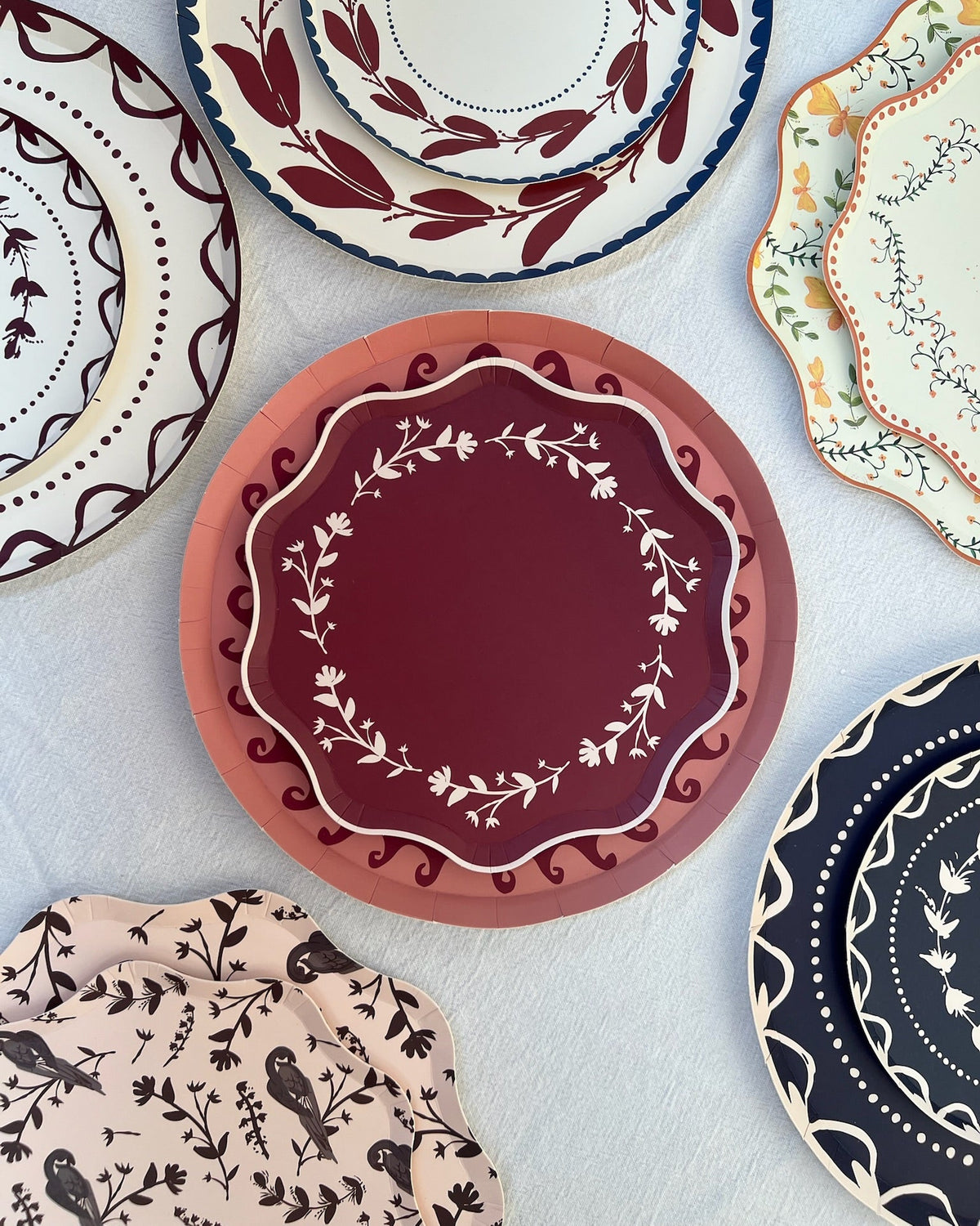 Collection of decorative plates with various patterns on a light background