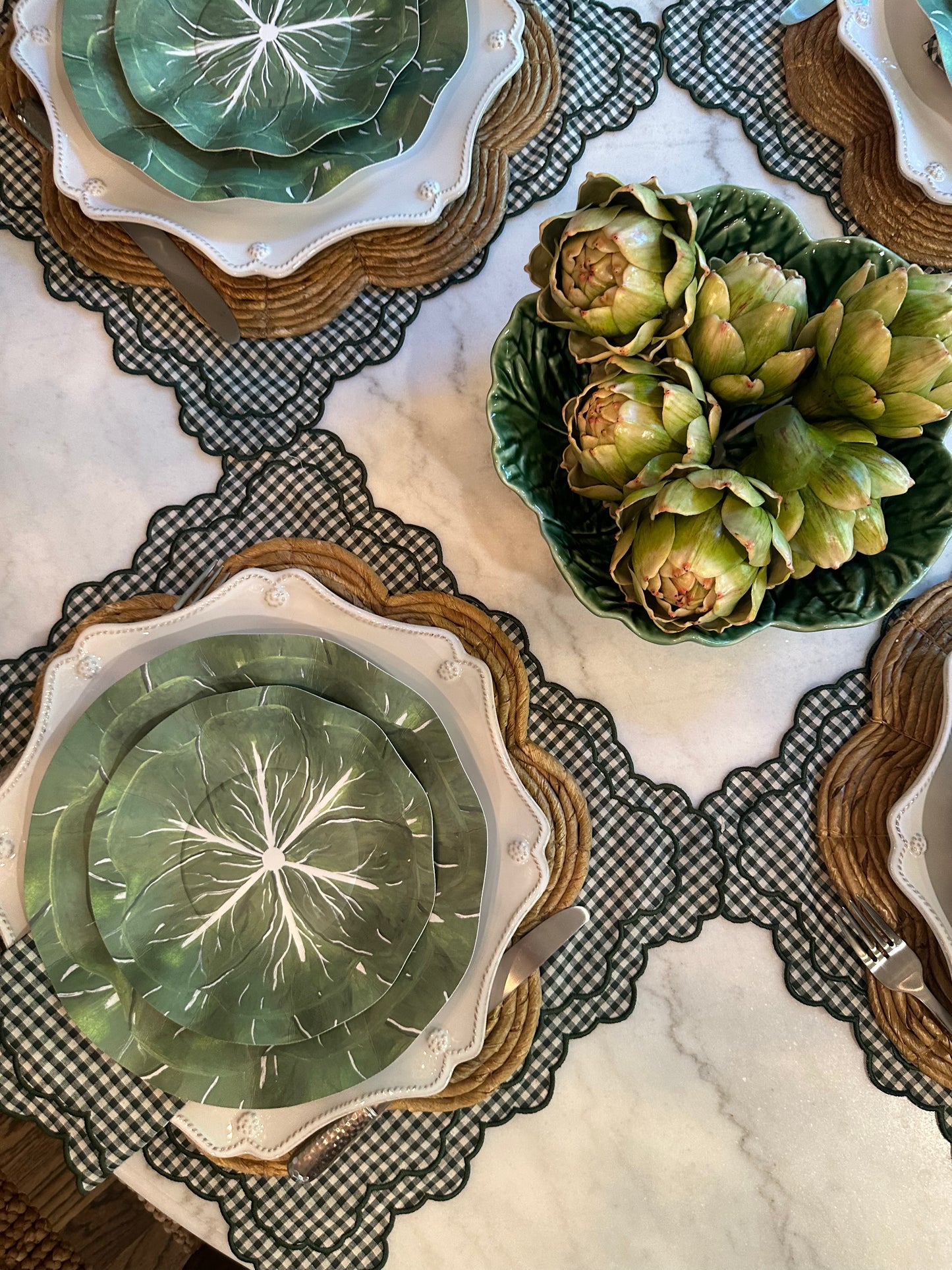 Paper plates with a cabbage design on green checkered placemats