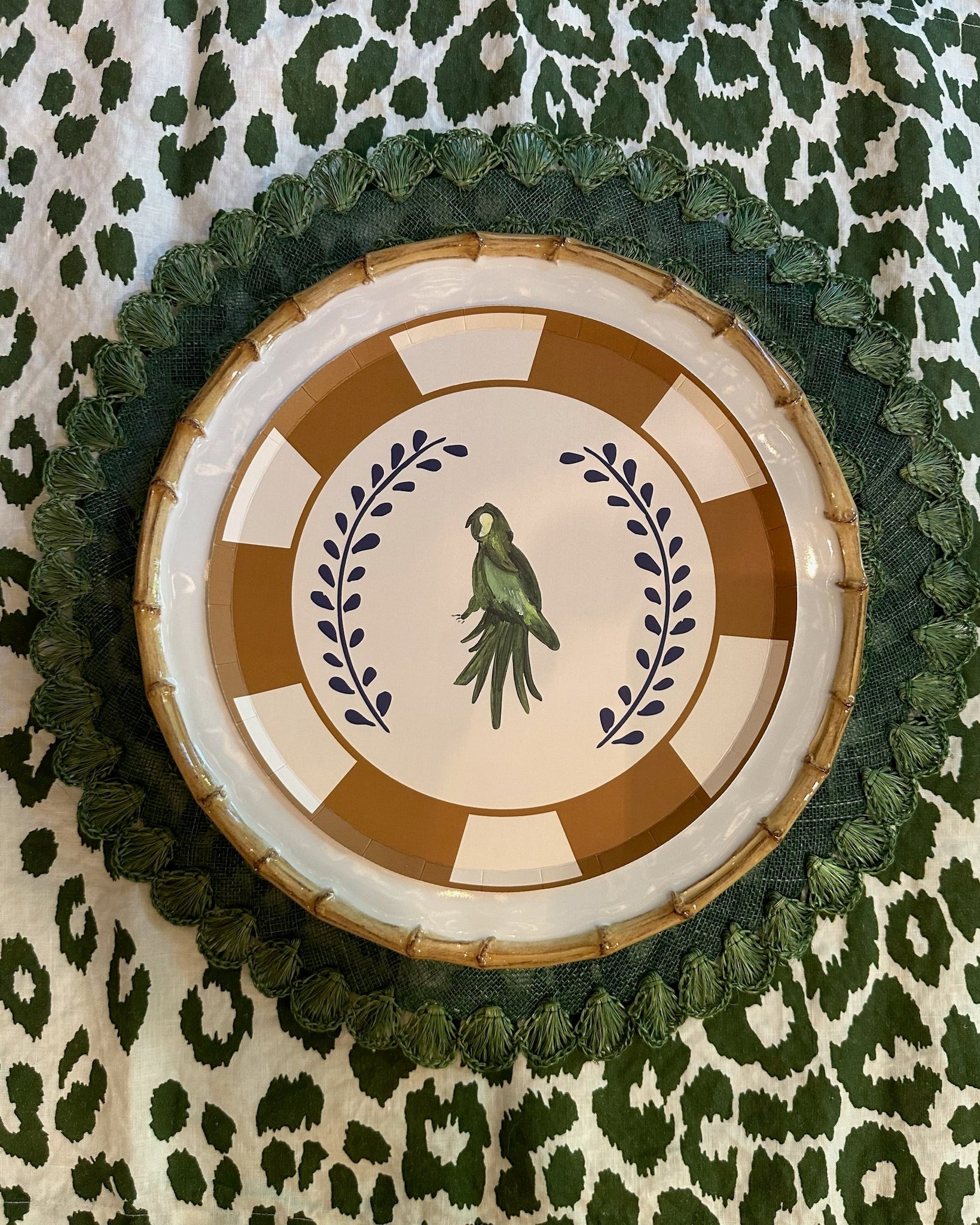 Decorative plate with a parrot design on a green and white patterned background