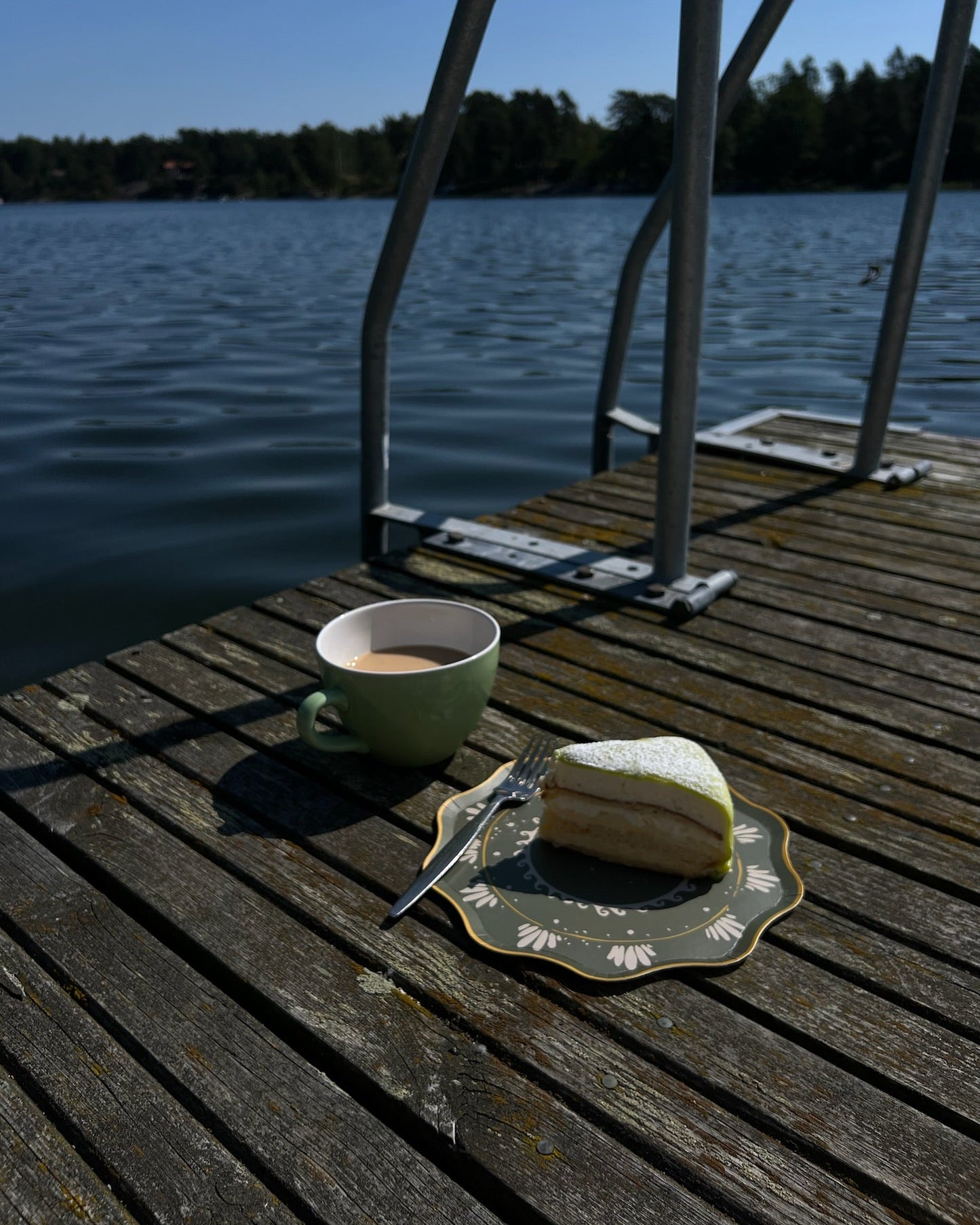 Cup of coffee and a piece of cake on a decorative plate