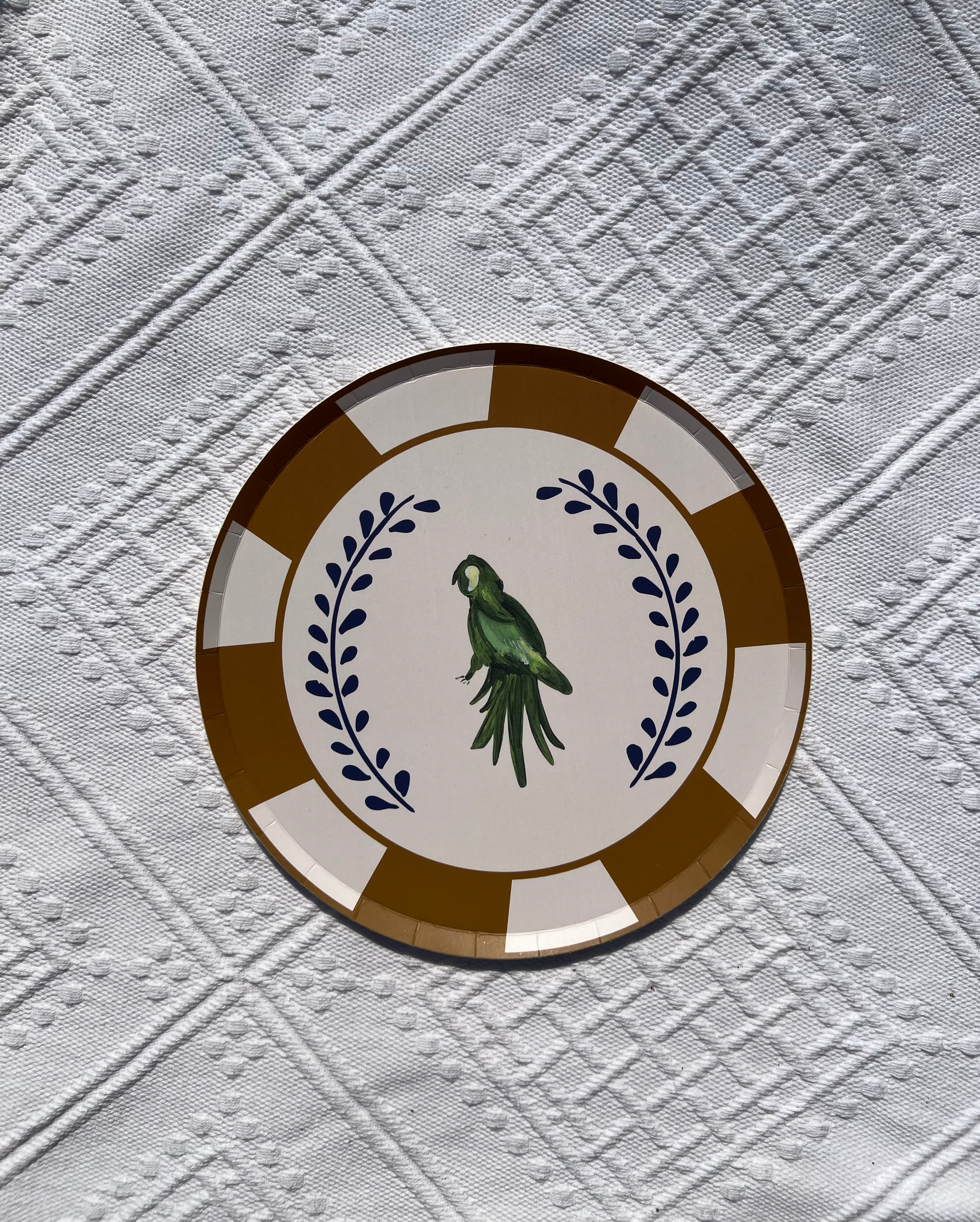 Decorative plate with a parrot design on a textured white background