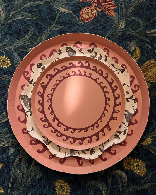 Decorative plates with intricate patterns on a floral background