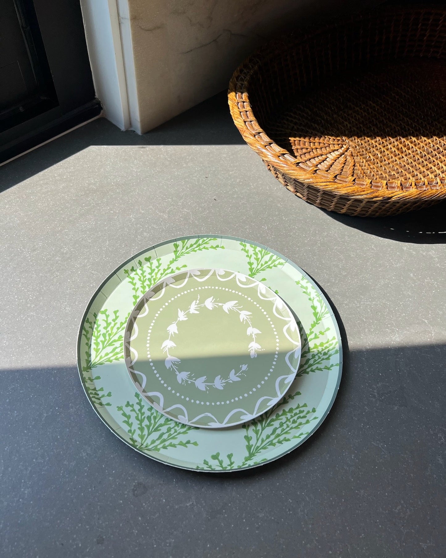 Decorative plates stacked on a countertop with sunlight hitting them