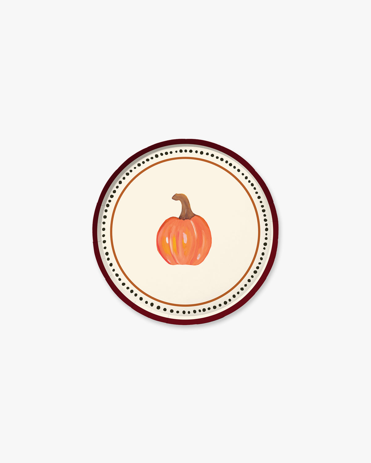 A round decorative plate featuring a central illustration of a small orange pumpkin with a brown stem, surrounded by concentric rings of black dots and a dark red outer border on a light cream background.