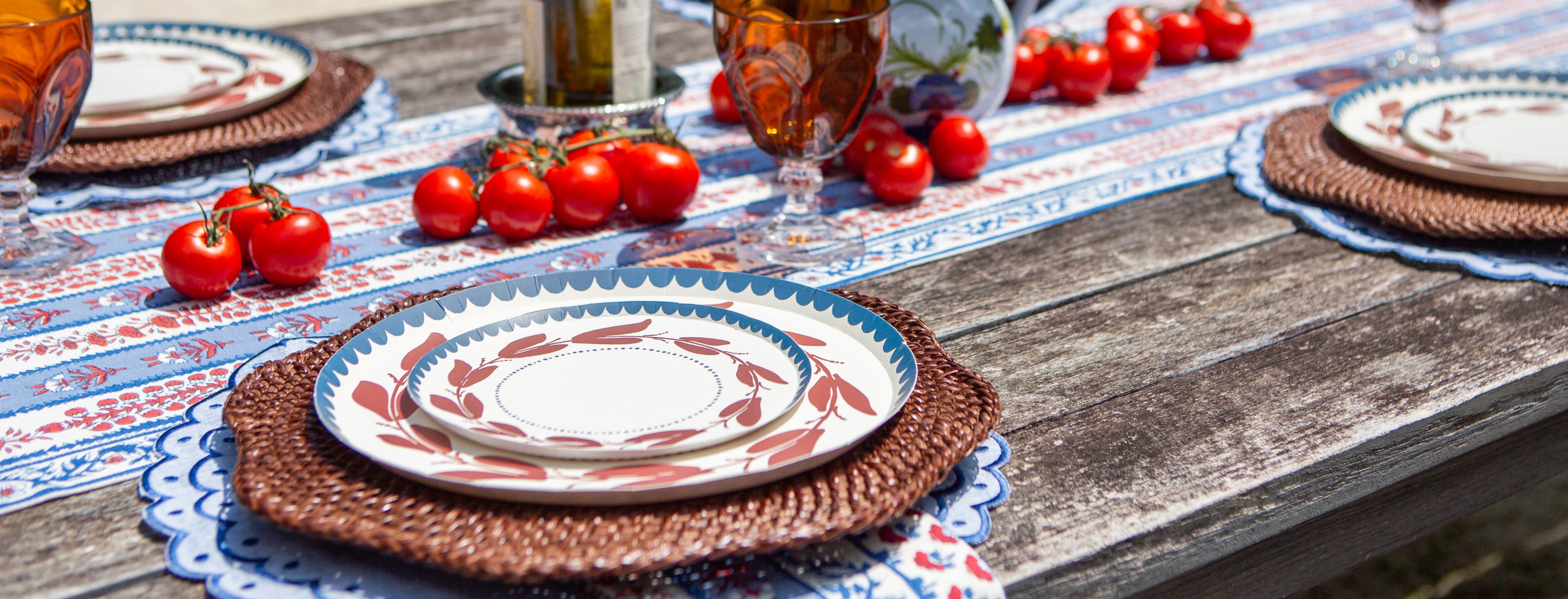 a red white and blue decorative plate with a leaf-like pattern