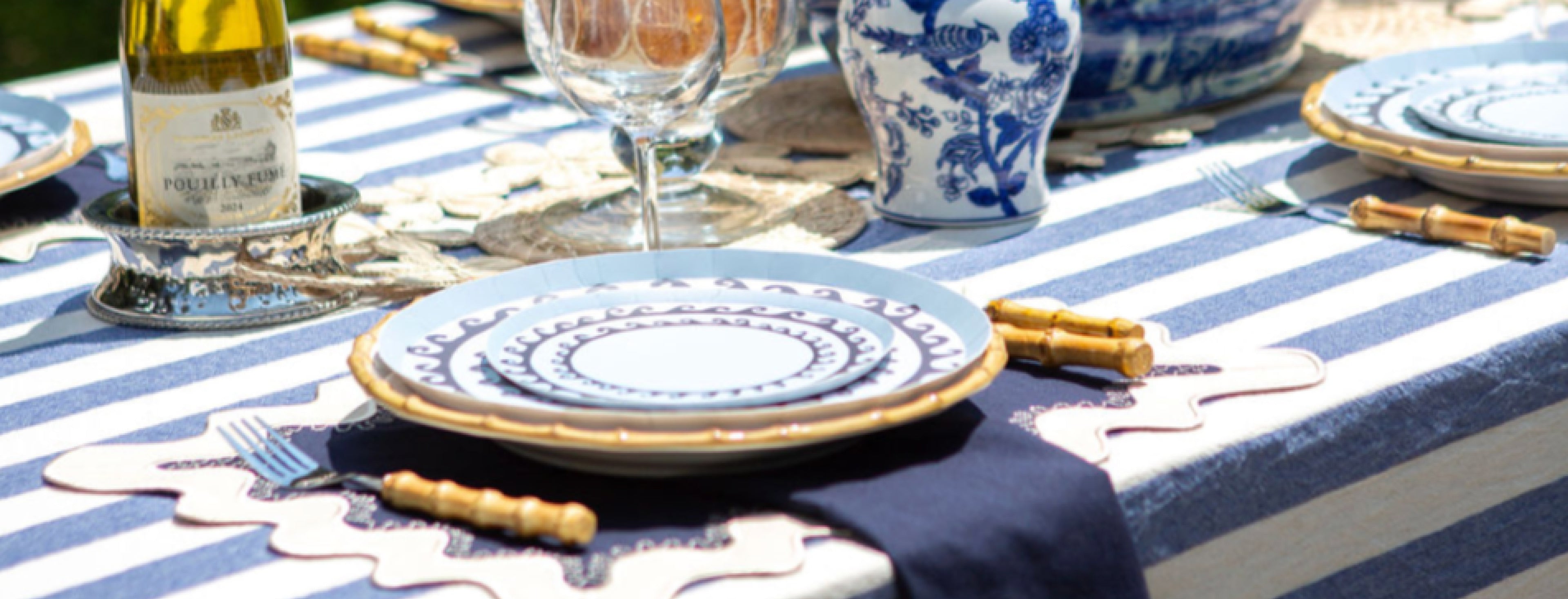 Decorative blue plates with darker blue wave pattern in a blue themed tablescape