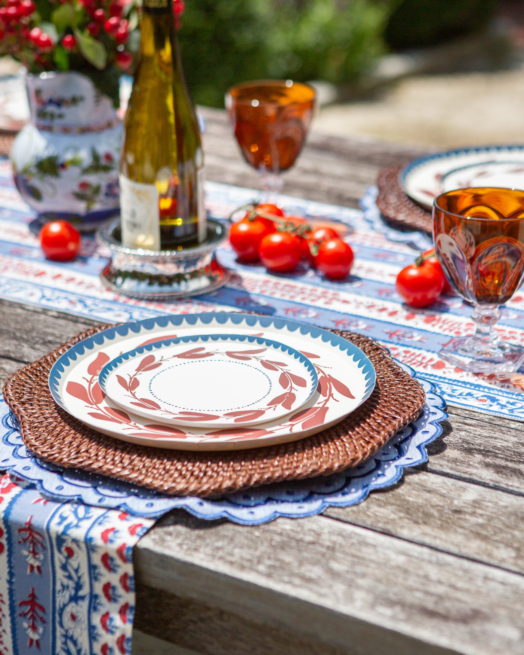 a red white and blue decorative plate with a leaf-like pattern