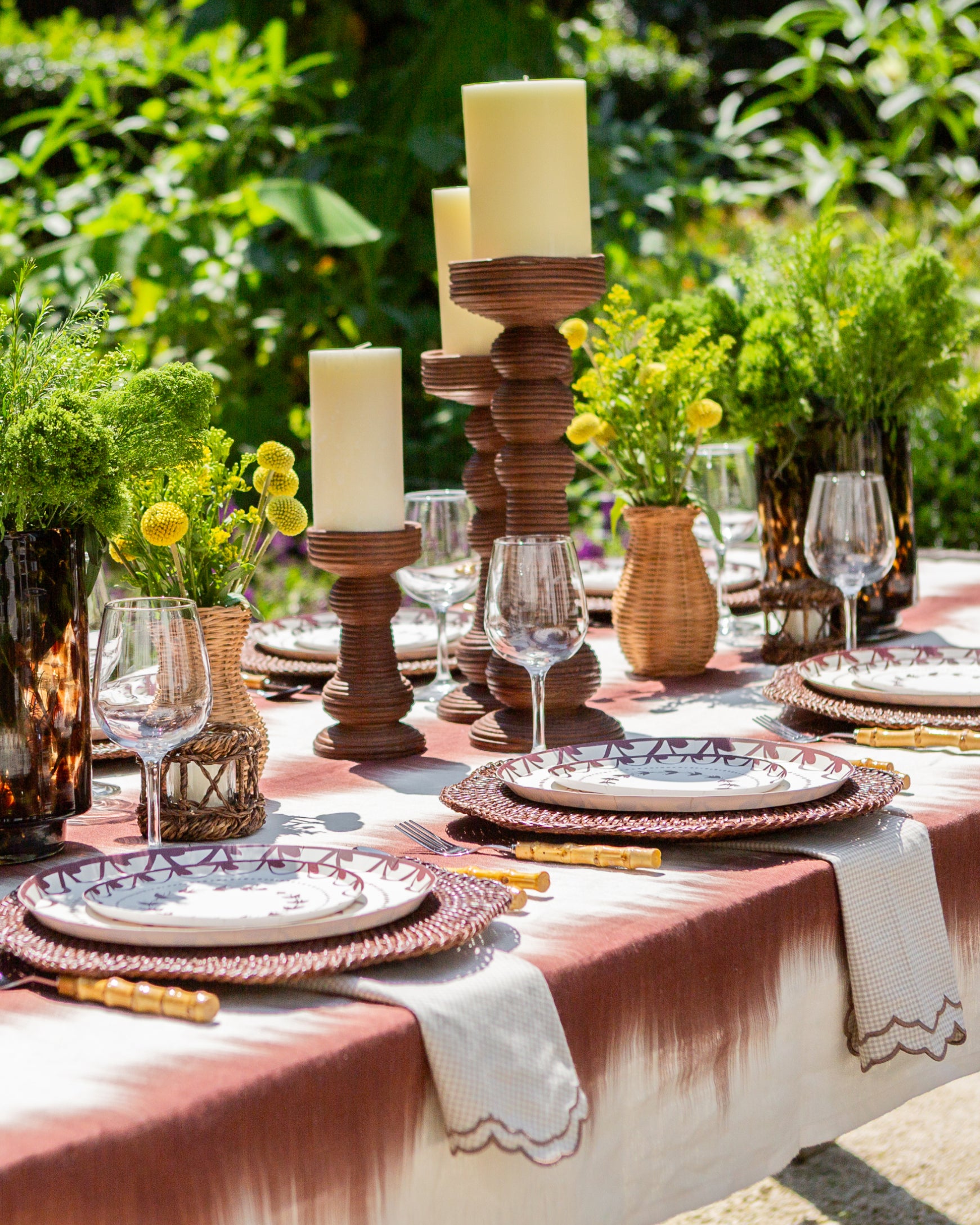 decorative plates and candlesticks in an outdoor tablescape