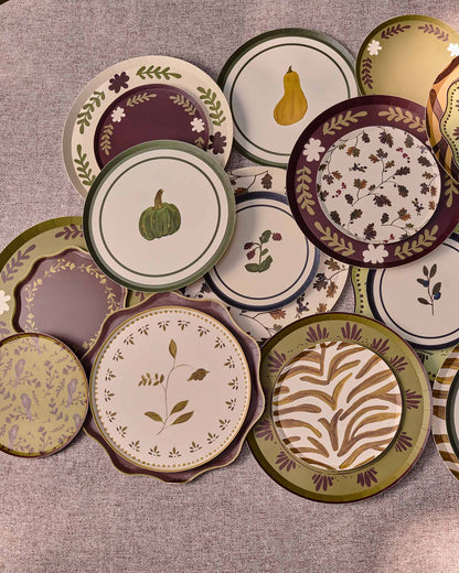 Decorative plates scattered and layered on a grey table