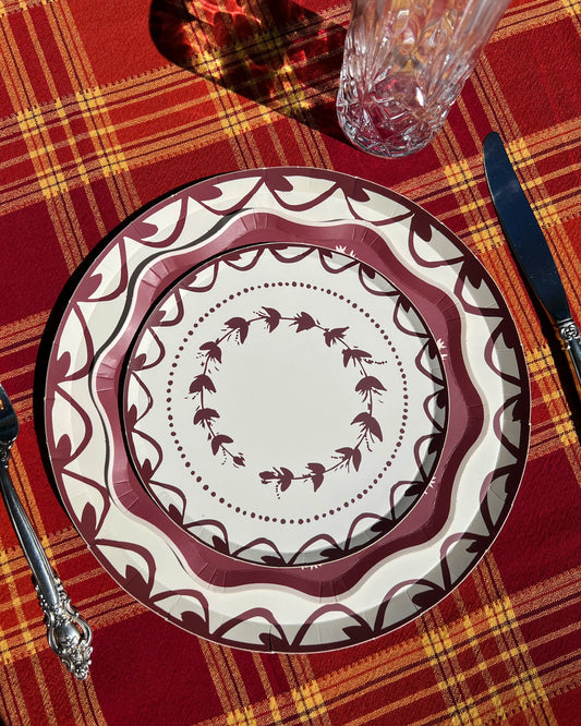 Decorative plate with intricate design on a red plaid tablecloth