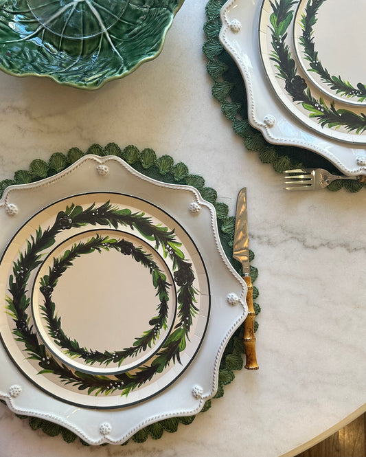 Decorative dinnerware set with green leaf patterns on a marble surface