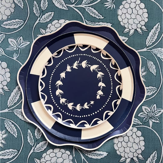 Decorative navy blue plate with white floral patterns on a floral patterned background