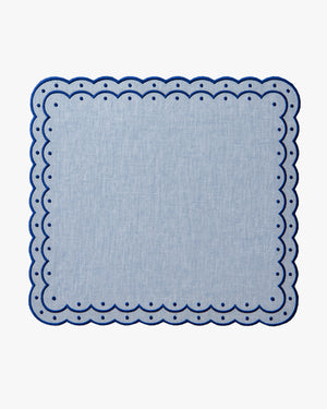 Chambray blue placemat with dark blue scalloped edges