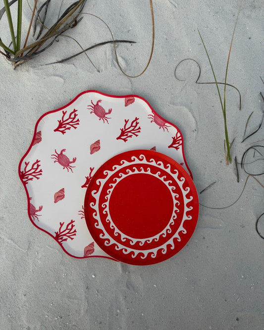 Decorative red and white plates in the sand