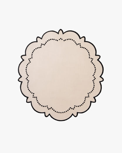 Round beige doily with a dotted border on a beige background