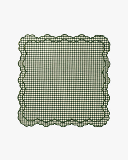 Green checkered napkin with scalloped edge on a white background