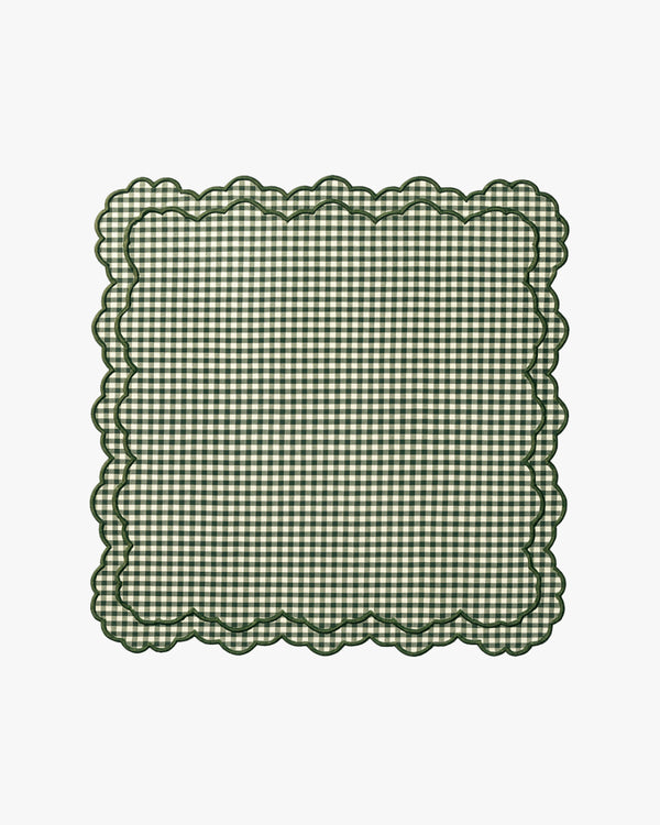 Green checkered napkin with scalloped edge on a white background