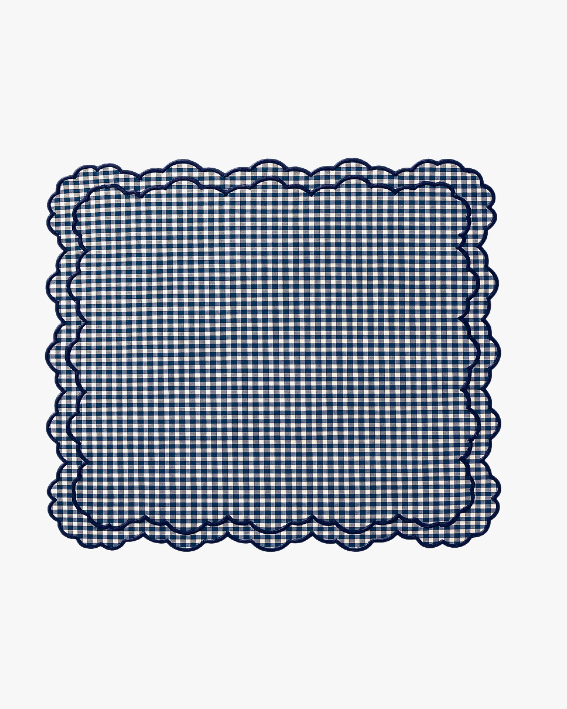 Navy blue and white checkered fabric with scalloped edge on a white background