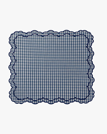 Navy blue and white checkered fabric with scalloped edge on a white background