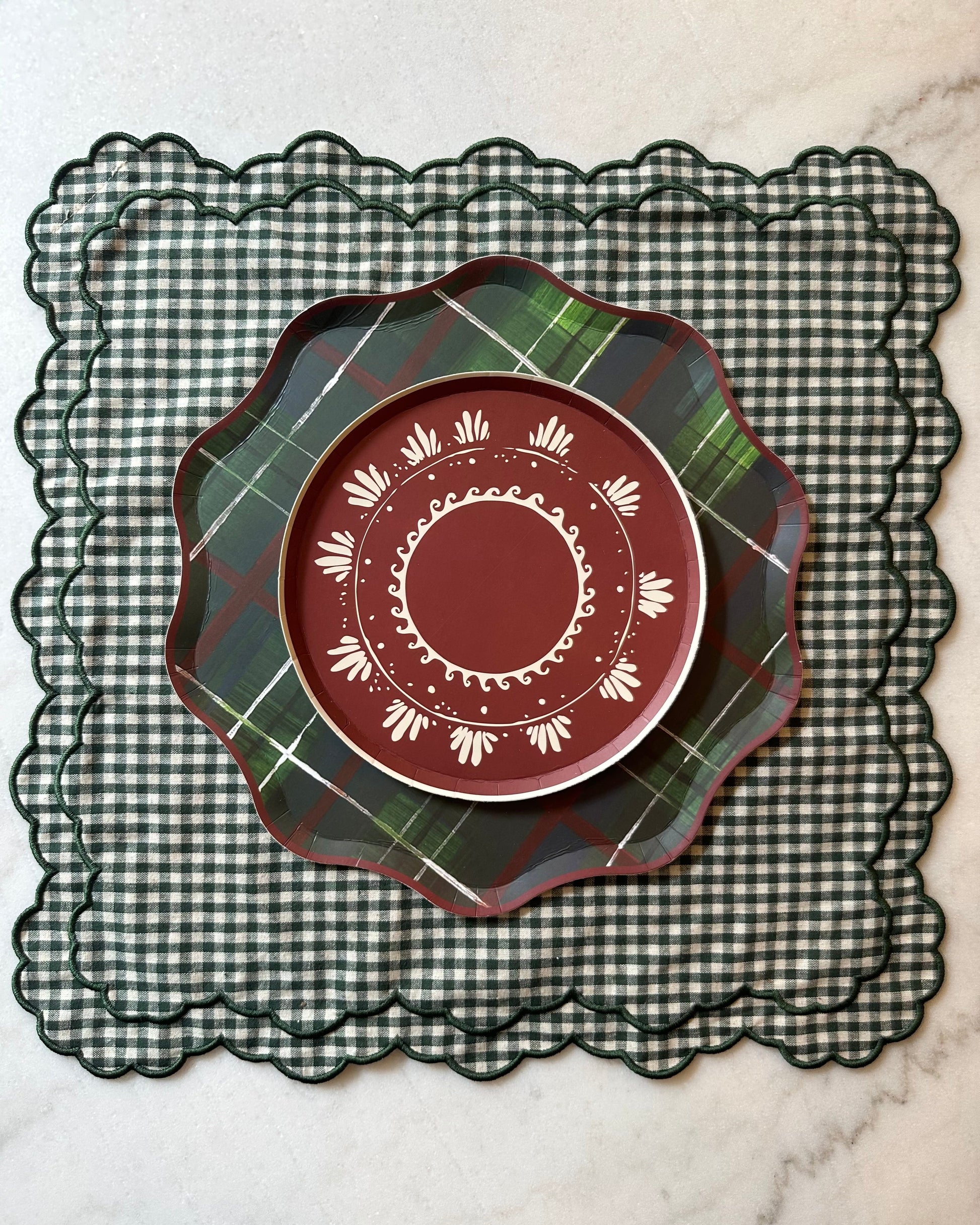 Patterned holiday plates on top of a checkered placemat