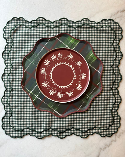 Patterned holiday plates on top of a checkered placemat
