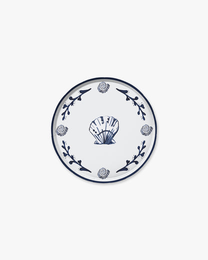 Decorative plate with blue shell design on a white background
