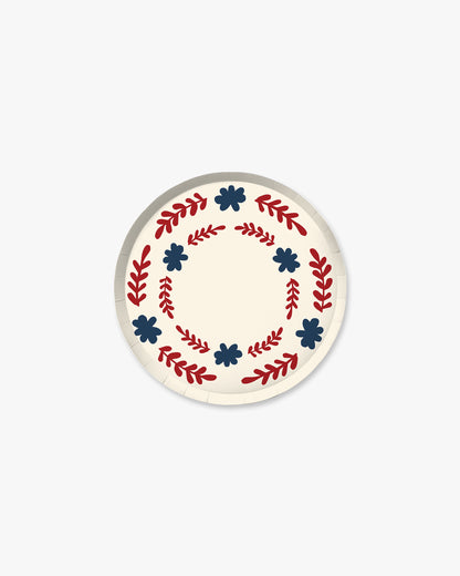 Round  plate with decorative red and blue patterns on a white background