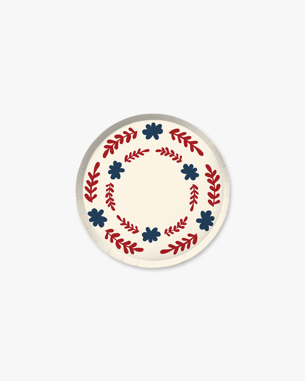 Round  plate with decorative red and blue patterns on a white background