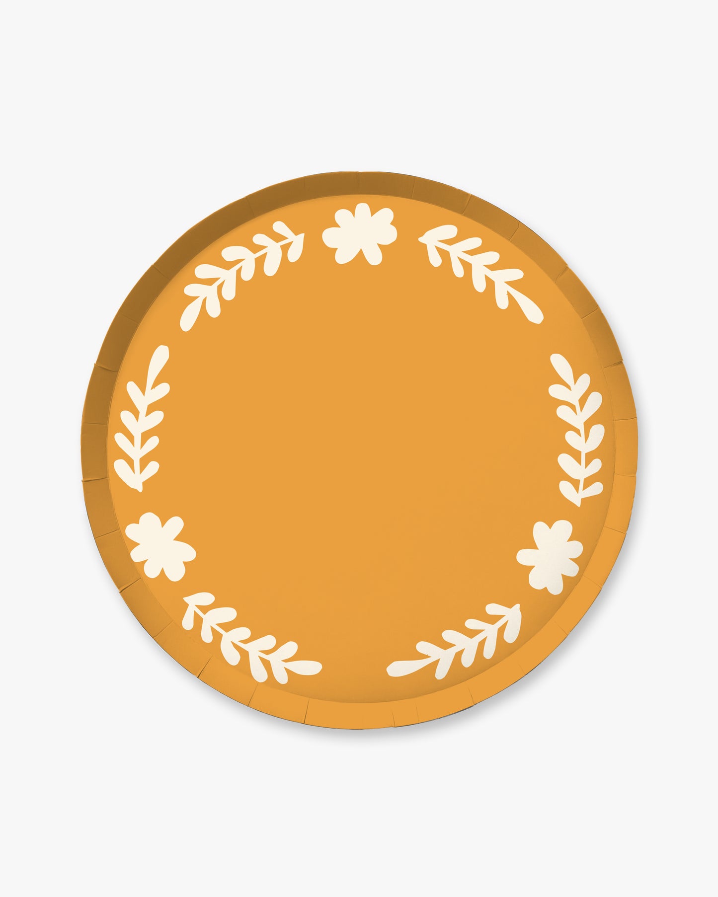 Round paper plate with floral design on an orange background