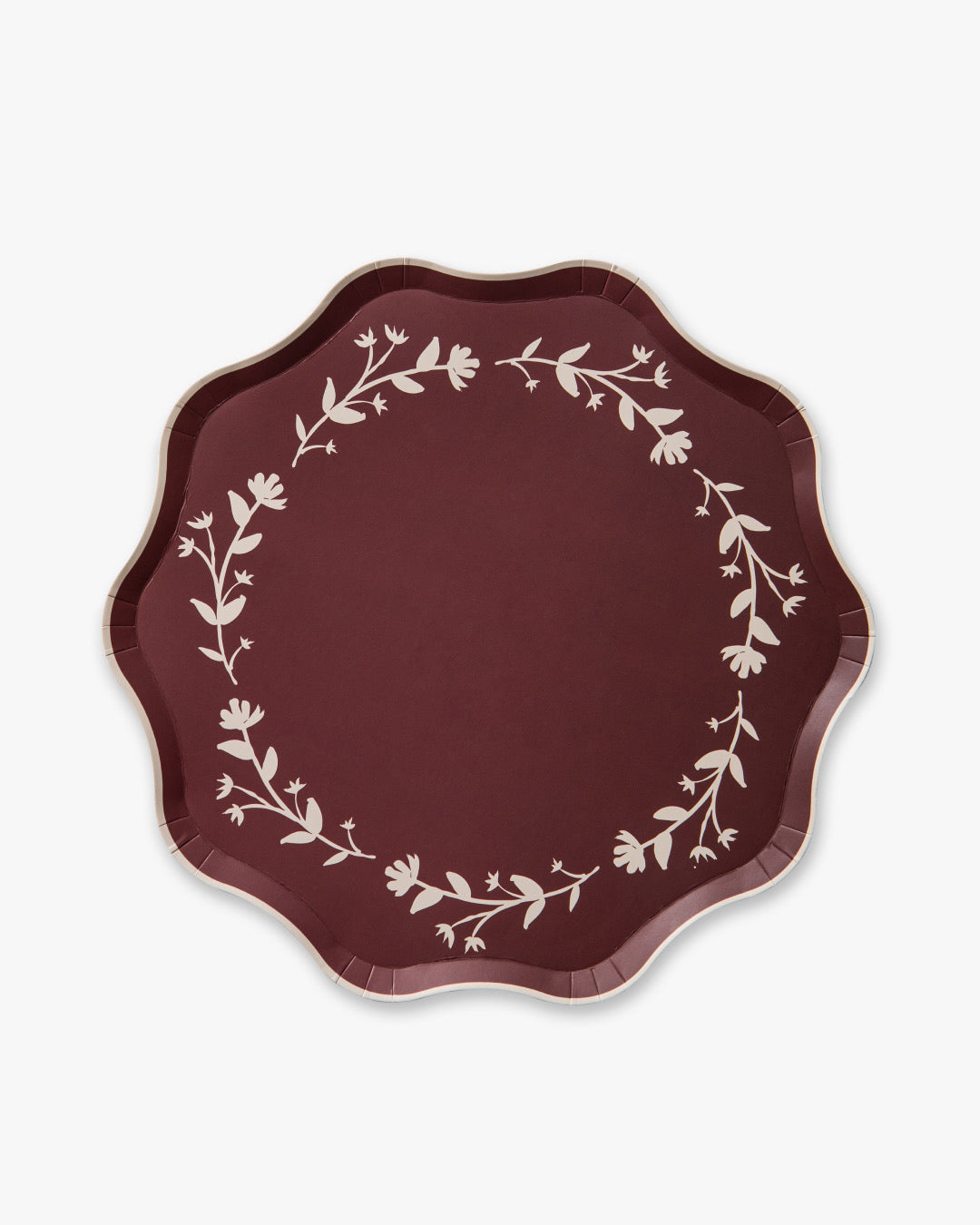 Round maroon plate with white floral patterns on a white background