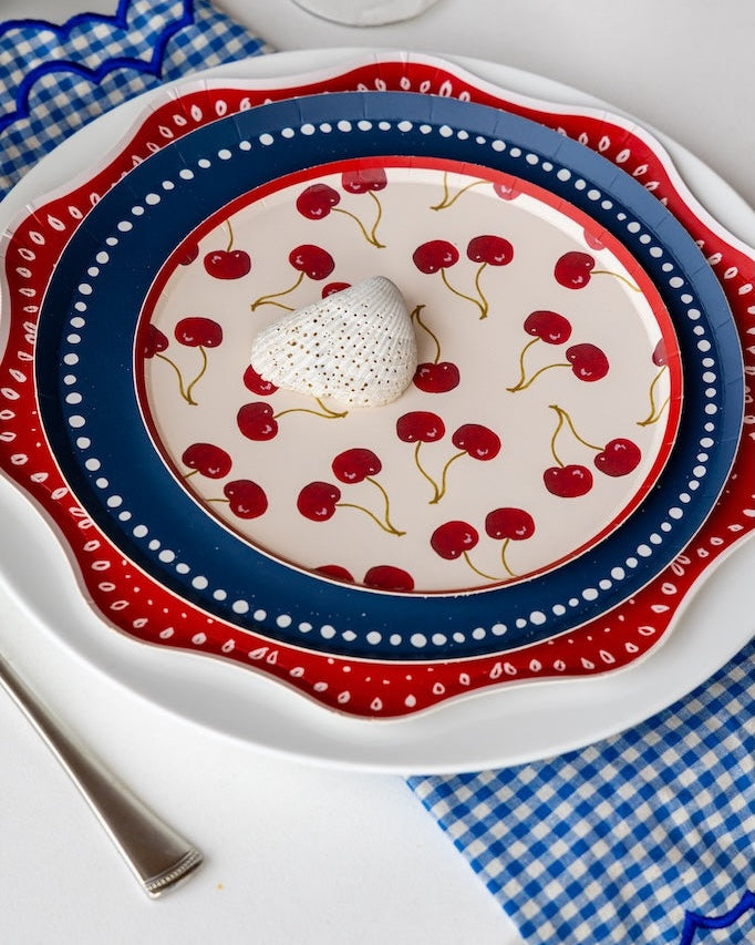 plates layered with cherries on top