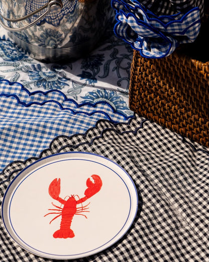 Plate with a  red lobster design on a checkered placemat