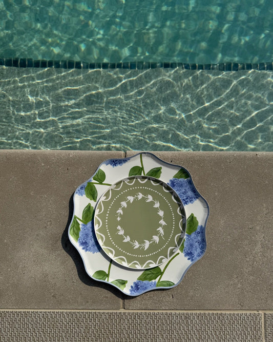 Decorative plates layered on a poolside concrete surface