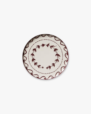 Decorative plate with a red floral pattern on a white background