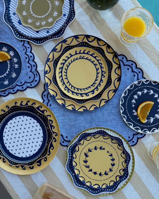 Blue and yellow decorative plates on a stripe tablecloth